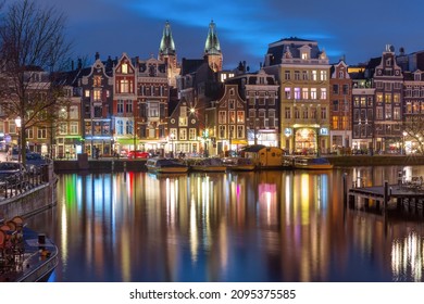 Evening Amsterdam canal Amstel with typical dutch houses at night, Holland, Netherlands.