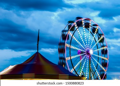 Evening Amusement Par Ride With Dark Dramatic Sky