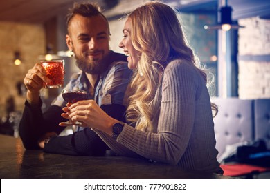 Evening at the bar. Romantic story in the bar. The guy and the girl met at the bar.
