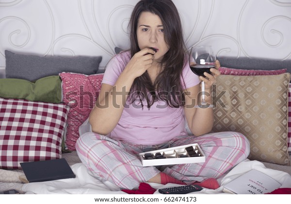 Evening in bed of lonely spinster with wine\
and chocolates