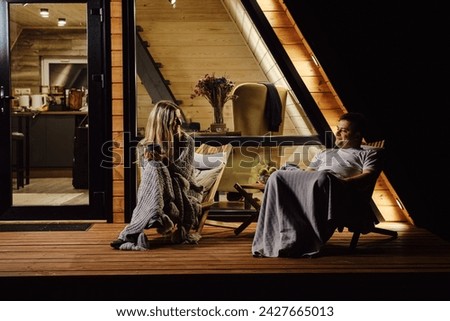 An evening conversation between a friendly couple on the terrace of tiny house