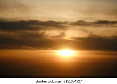 Evening Dramatic Sky With Clouds During Sunset. The Sun Sets Behind Dark Clouds