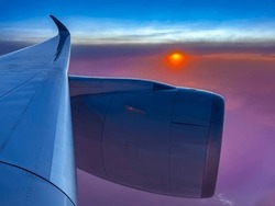 An Evening At Fourty Thousand Feet. Sunset View From Jetliner's Window. Higher Altitude Skyscape Is Stunning With Blue, Orange, Red, Yellow And Gray-black Perhaps Over And Near The Waters Of Japan