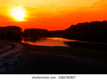 Evening Idyllic Landscape With Sun Going Down Above The River