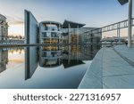 Evening mood at sunset in the government district of Berlin with reflection on the water surface of the river Spree. Government building Paul Loebe Haus in the capital of Germany.