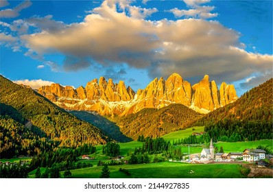 Evening in a mountain village in Alps. Mountain Alpine village at sunset. Alpine mountain village landscape. Mountain village in Alps at sundown