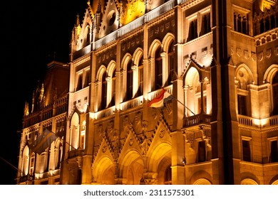 Evening photo of the Parliament building in Budapest.The majestic Saxon architecture is illuminated with warm yellow light. Budapest, Hungary - 08.24.2022 - Shutterstock ID 2311575301