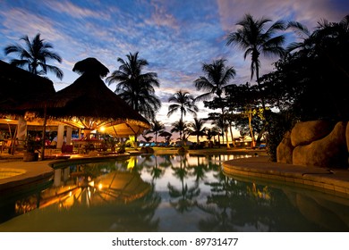 Evening picture of the swimming pool area on a resort - Powered by Shutterstock