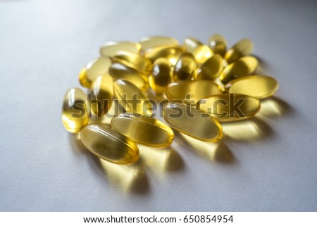 Evening primrose oil supplement capsules on neutral backgrond