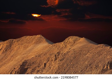 Evening red sunset sky over mountain Sodom Gomorrah in Dead sea from Negev desert, Israel. The mountains of Sodom located on the south-west side of the Dead Sea. Sunset on a foggy mountain range Sodom - Shutterstock ID 2198084577