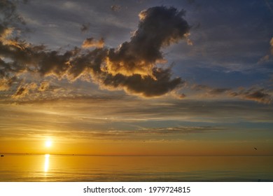 Evening sky with dramatic clouds over the sea. Dramatic sunset over the sea. - Shutterstock ID 1979724815