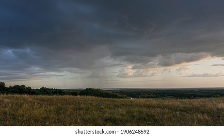 Evening sky and rain clouds, countryside landscape. Summer season, august.