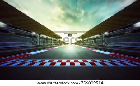 Evening speedy motion blur international race track with starting finishing line and light .