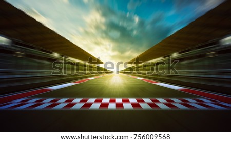 Evening speedy motion blur international race track with starting and finishing line .