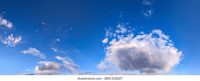 An evening sunset of intermingled cloud patches creates a layered, three-dimensional panoramic picture. The interplay of orange and blue tones blends magically with the setting and shadow. The river reflects the colors of the sky in its waves.