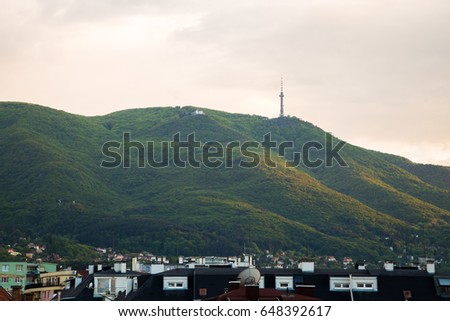 Evening sunset view in glowing light of the Vitosha Mountain and rooftops of the city of Sofia in spring, the capital of Bulgaria