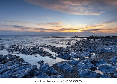 Evening tide on the dramatic coast in Aberystwyth at sunset. - Shutterstock ID 2366492375