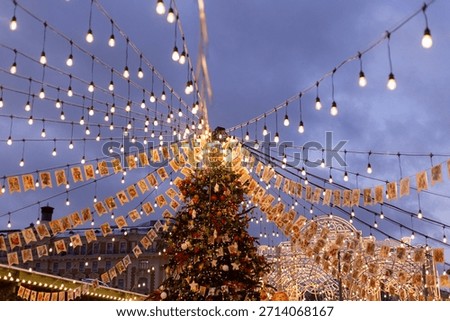 Evening Tree Lighting Ceremony Under Cascading Bulbs, Event Host Coordinating Moment, Triangular Flags Fluttering, Soft .