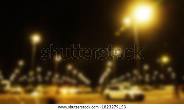 evening urban landscape, blurred focus (blurred space)
car parking, shining lights, many cars in the parking lot          
                   