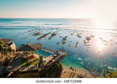 Evening View Of The Beach Club Swimming Pool And The Sea In Uluwatu, Bali Island