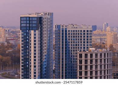 Evening view of the city. Sunset orange sky and beautiful cityscape, buildings and city streets, public place - Powered by Shutterstock