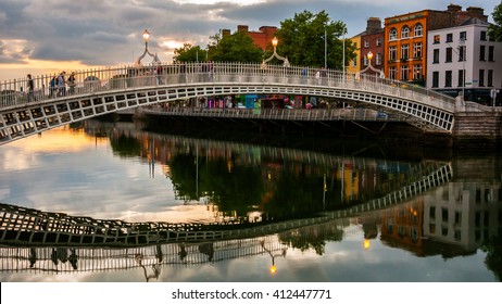 Evening view of famous Ha Penny Bridge in Dublin, Ireland at sunset