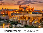 Evening view at the Mosque-Cathedral with Roman bridge in Cordoba - Spain
