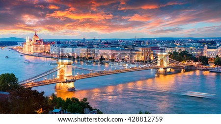 Evening view of Parliament and Chain Bridge in Pest city. Colorful sanset in Budapest, Hungary, Europe. Artistic style post processed photo.