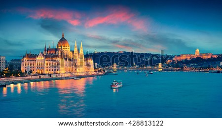 Evening view of Parliament, Chain Bridge and Buda Castle. Colorful sanset in Budapest, Hungary, Europe. Artistic style post processed photo.