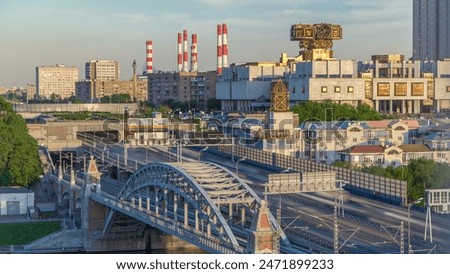Evening view to the Russian Academy of Sciences timelapse at sunset and Novoandreevsky Bridge over the Moscow River. Aerial view from rooftop. Traffic on the road