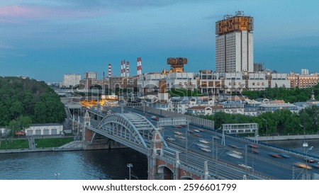 Evening view at the Russian Academy of Sciences day to night transition timelapse and Novoandreevsky Bridge over the Moscow River. Aerial view from rooftop after sunset