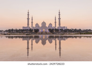 Evening view of Sheikh Zayed Grand Mosque in Abu Dhabi reflecting in a water, United Arab Emirates. - Powered by Shutterstock