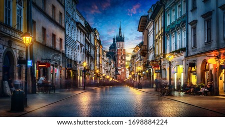 Evening view of St. Mary's Basilica from the Florianska street, old town Krakow, Poland. Panoramic view, long exposure, timelapse.  