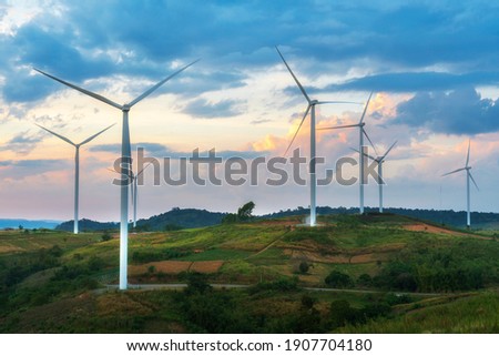 Evening view of wind turbines or windmills farm field and mountain hill in Phetchabun, Thailand.