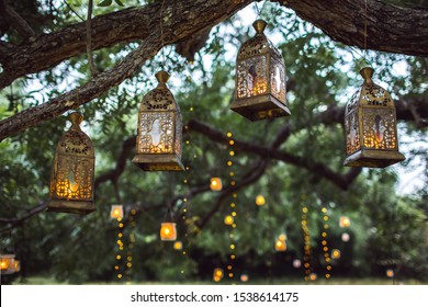 Evening Wedding Ceremony With A Lot Of Vintage Lanterns, Lamps, Candles. Unusual Outdoor Ceremony Decoration. Beautiful Garden Party Concept.