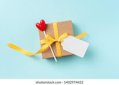 event design concept - top view of fathers day layout with yellow ribbon gift box, blank label, heart decoration, copy space for mock up - Powered by Shutterstock