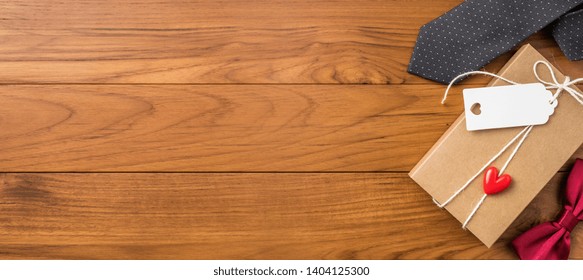 event design concept - top view of fathers day layout with kraft gift box, silhouette of eye glasses and beard, butterfly bow tie, copy space for mock up - Powered by Shutterstock