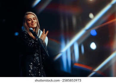 
 Event Host Applauding while Presenting an Award Show
Cheerful presenter hosting a ceremony in the entertainment industry

