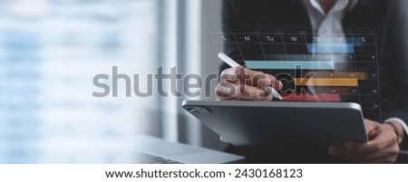 Event manager using digital tablet with monthly calendar planner for event planning and manages time for effective work. 2024 Event planner timetable agenda plan, electronic personal organizing
