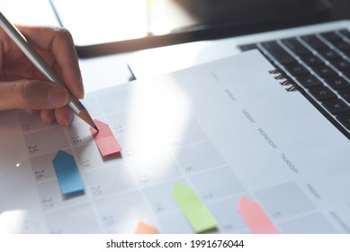 Event planner timetable agenda plan on organize schedule event. Business woman taking note on calendar with laptop computer on office table. Calendar event plan, work planning, project management - Powered by Shutterstock