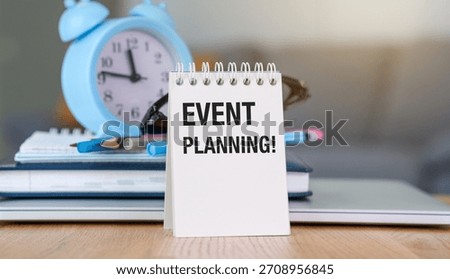 Event Planning is important for organizing and executing successful events. A white planner with the word Event Planning written on it, along with a clock and some pens