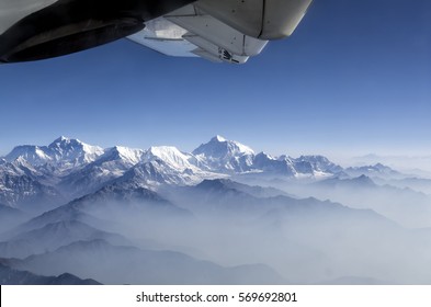 Everest Peak and Himalaya Everest mountain range panorama view through plane window