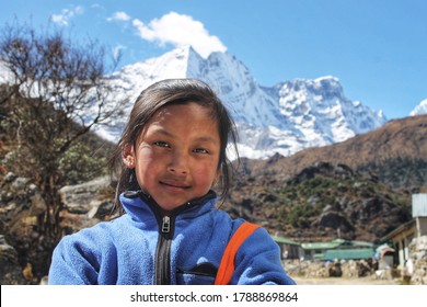 Everest Region, Nepal - August, 2021: The People Of Nepal. Portrait Of A Local Indigenous Kids In A Village In The Nepalese Himalayas.