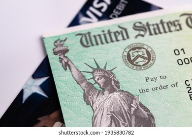 Everett, WA - USA- 03-13-2021: US Treasury Department Check on Top of Debit Card Represents Stimulus Check Relief Package - Shutterstock ID 1935830782