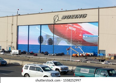 Everett, Washington / USA - November 6 2019: Boeing sign on the airplane hangar at the Dreamliner, 777, and 747 factory, with traffic in the foreground