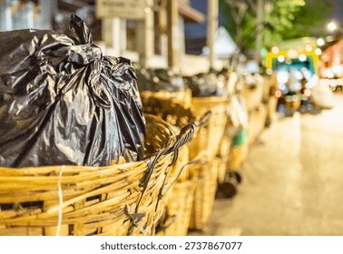 Every evening rows of black bin bags,loaded with trash,waste and garbage line the streets,before being taken by the municipal refuse collection dustcart.