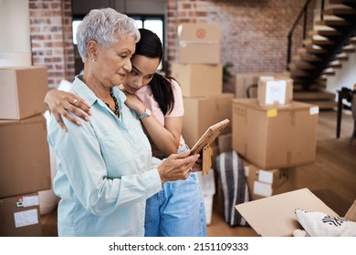 Every home has a history. Shot of a senior woman looking at a photograph with her daughter while packing boxes on moving day. - Powered by Shutterstock