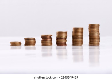 Every Little Bit Helps. Studio Shot Of Columns Of Coins Isolated On A White Background.