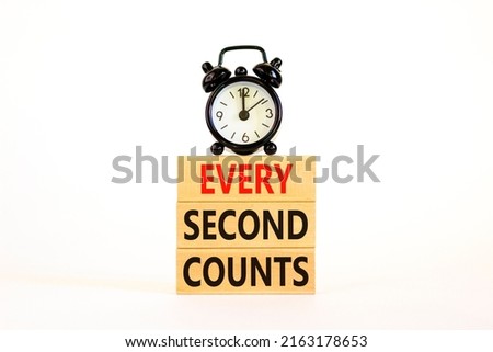 Every second counts symbol. Concept words Every second counts on wooden blocks on a beautiful white table white background. Black alarm clock. Business, motivational and every second counts concept.
