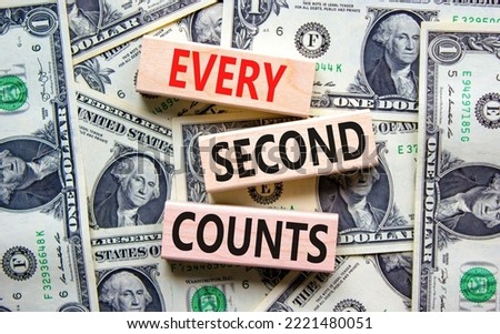 Every second counts symbol. Concept words Every second counts on wooden blocks on a beautiful background from dollar bills. Business, motivational and every second counts concept. Copy space.